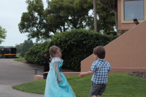 Little girl and boy playing outside