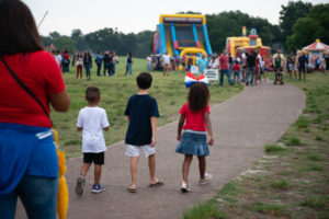 Children walking to bounce house and inflatable slide