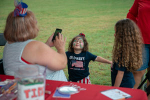 Little girl wearing blue facepaint
