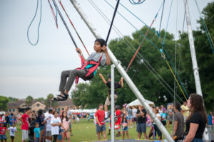 Boy on bungee ride during music works festival