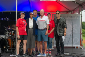 Happy men and women on stage at Music Works festival
