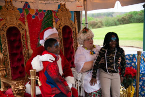 Girl and boy visiting Mrs and Mr Claus