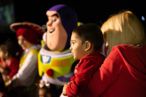 Boy and woman looking on at winter fest