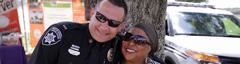 Safety officer and woman smiling together at safety event